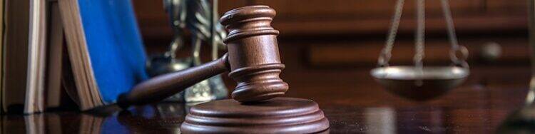 Law and Justice concept with gavel and scale in background. Composition in court library